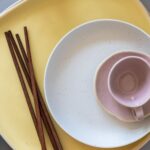 Flat lay of ceramic plates and chopsticks showcasing modern minimalist design.