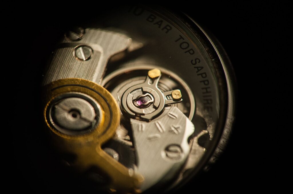Detailed macro shot of a watch mechanism highlighting gears and jewels.