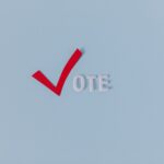 Red check mark with the word "VOTE" on a blue background, symbolizing election participation.