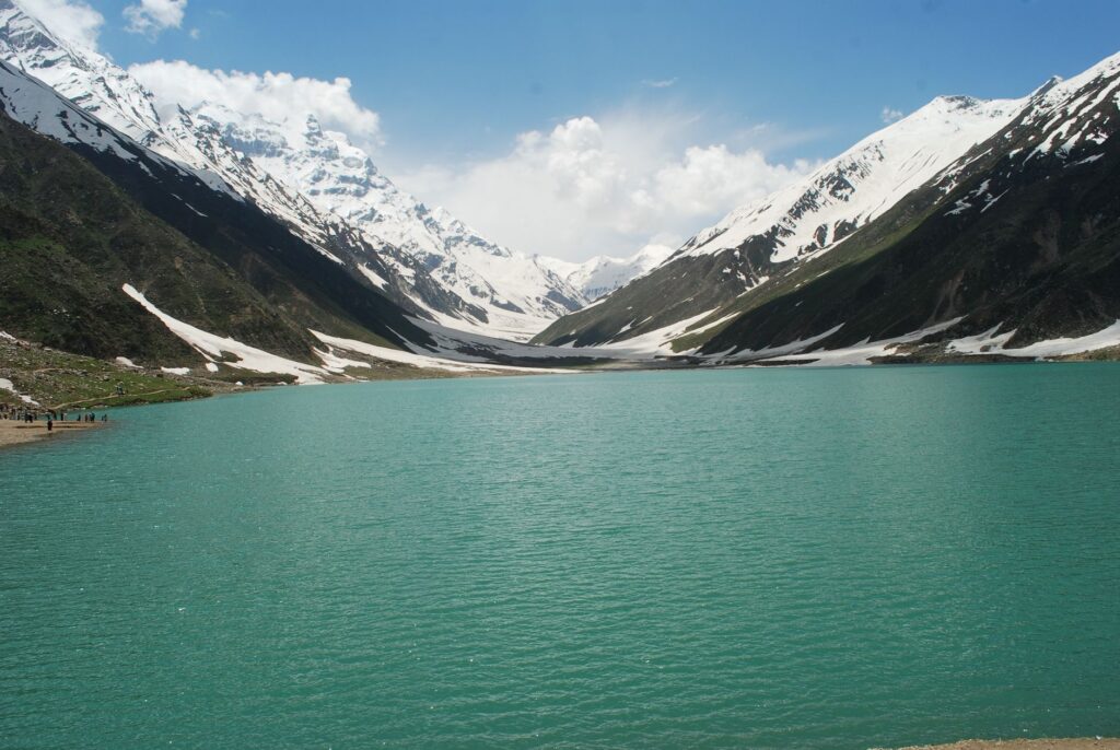 Beautiful Lake Saif-ul-Malook surrounded by snow-covered mountains in Khyber Pakhtunkhwa, Pakistan.