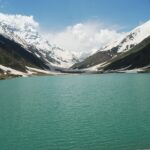 Beautiful Lake Saif-ul-Malook surrounded by snow-covered mountains in Khyber Pakhtunkhwa, Pakistan.