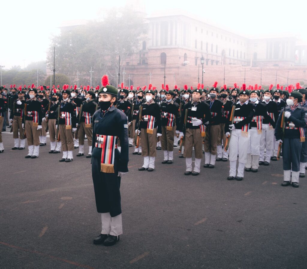 A large group of soldiers in uniform standing in formation during a military parade outdoors.
