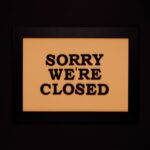 Black-framed 'Sorry We're Closed' sign against a dark backdrop, ideal for business themes.
