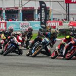Thrilling motorcycle race in Tarlac City with riders taking sharp turns on the racetrack.
