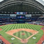 Aerial view of the Rogers Centre stadium during a baseball game in Toronto, displaying its retractable roof.