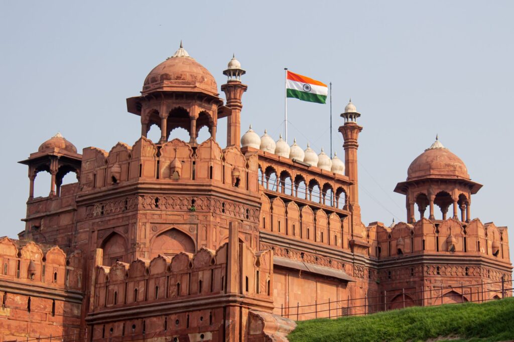 Front view of the historic Red Fort in New Delhi with the Indian flag waving.