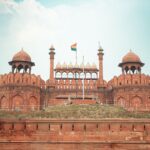 Front view of the historic Red Fort in New Delhi, featuring its iconic architecture and Indian flag.