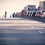 A congested highway with cars and trucks in a traffic jam during daylight.