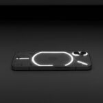 Minimalist photo of a glowing smartphone with a transparent back design on a dark surface.