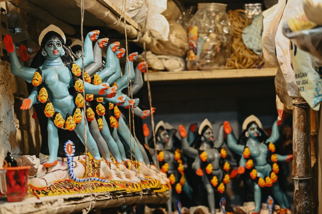 Vibrant handmade Goddess Kali idols displayed in a Kolkata workshop.