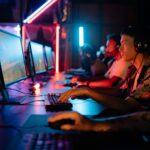 Group of gamers immersed in competitive esports at a cyber arena with neon lighting.