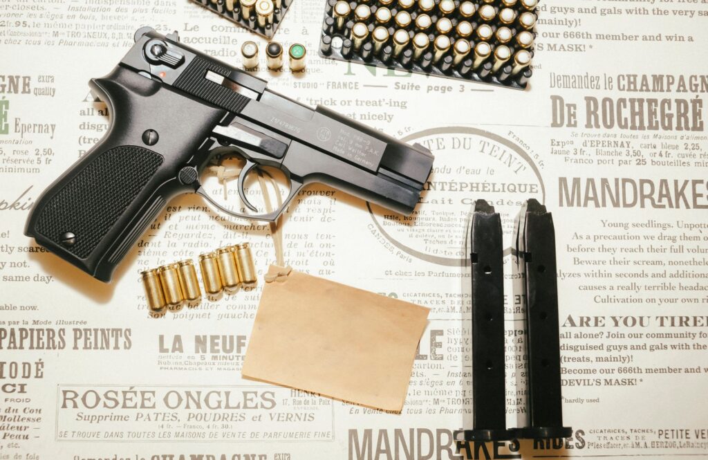 A handgun, spare magazines, and bullets displayed on a vintage paper background, emphasizing firearm themes.