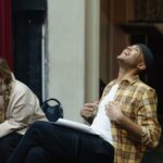 Two actors rehearsing a scene in a theater, showcasing emotions and expression.