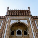 A detailed view of the stunning Safdarjung Tomb facade in New Delhi, showcasing intricate Mughal architecture.