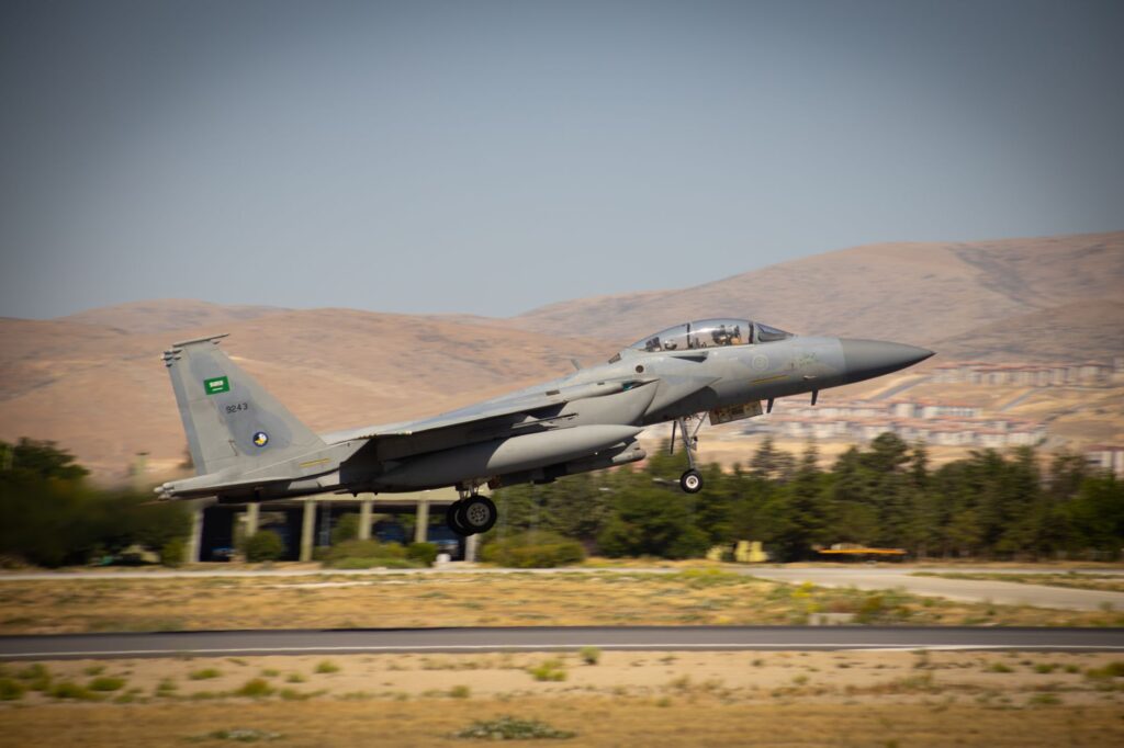 F-15 military jet taking off from Konya runway with Saudi Arabian markings.