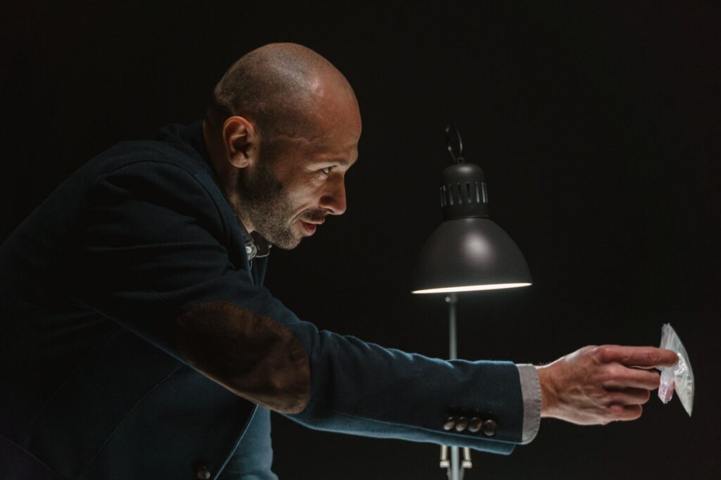 A detective presenting evidence during an intense interrogation scene.