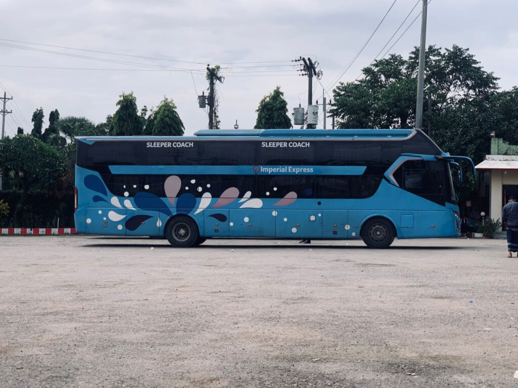 Side view of Imperial Express sleeper coach bus in Dhaka, Bangladesh.