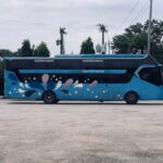 Side view of Imperial Express sleeper coach bus in Dhaka, Bangladesh.