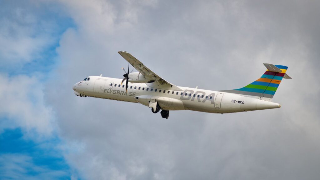 A vibrant ATR 72-500 airplane soaring through the sky, showcasing aviation dynamics and travel concepts.