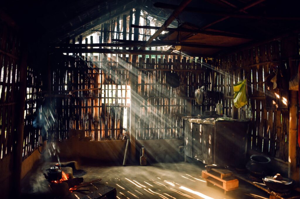 Sunlight streaming through a rustic bamboo hut creating a warm, serene atmosphere.