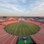 Wide-angle aerial view of the iconic Narendra Modi Stadium in Ahmedabad, India, at day.