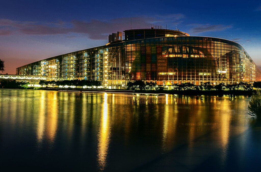 Stunning night view of the European Parliament in Strasbourg, beautifully reflected in the water.