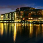 Stunning night view of the European Parliament in Strasbourg, beautifully reflected in the water.