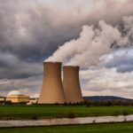 Scenic view of a nuclear power plant with cooling towers emitting steam in Hameln, Germany.