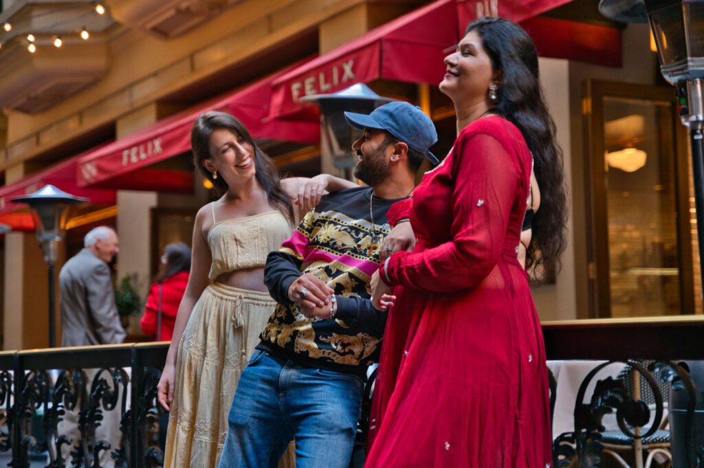 Three friends enjoying a cheerful moment at Felix café in Sydney, Australia.