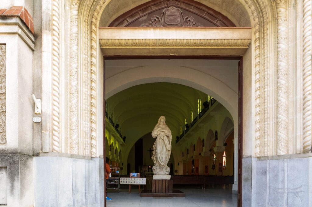 Explore the beauty of this church entrance with a detailed religious statue inside.