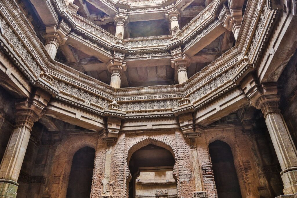 A stunning view of the intricately designed ancient stepwell architecture with stone columns.