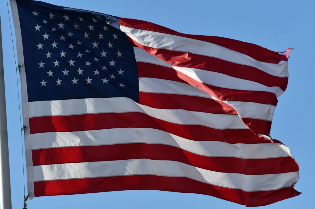 Close-up of the USA flag waving outdoors, symbolizing freedom and patriotism.