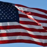 Close-up of the USA flag waving outdoors, symbolizing freedom and patriotism.