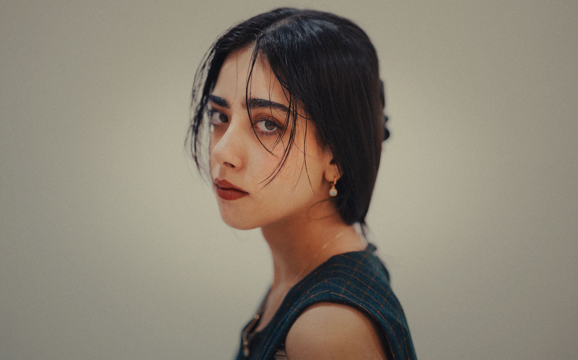 Captivating portrait of a woman with dark hair, showcasing elegance and timeless beauty.