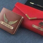 Stylish leather wallet and purse set with personalized pen on blue fabric. Ideal for fashion accessories.