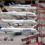 Detailed miniature model of an airport terminal with various aircraft brands on display.
