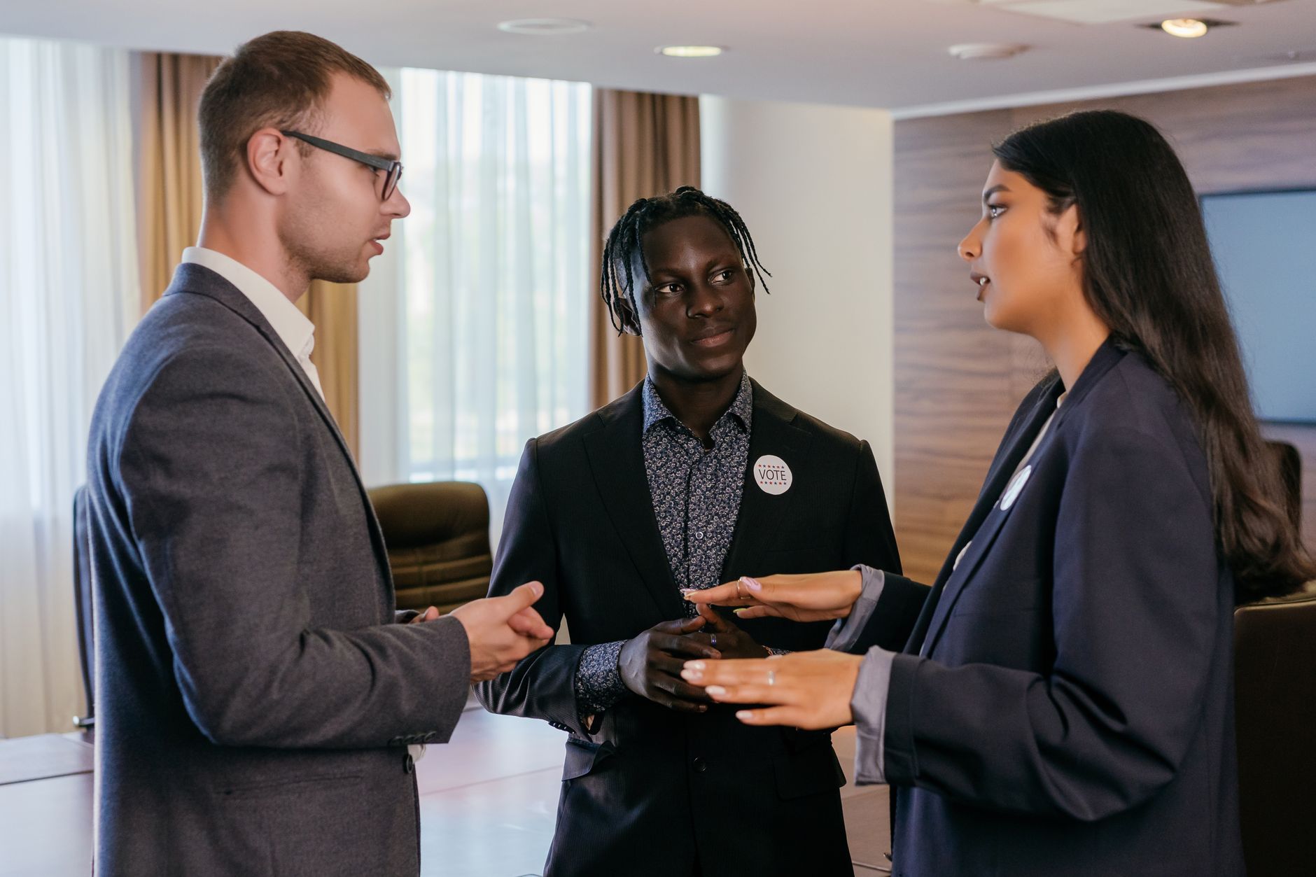 Group of professionals engaged in discussion in a modern conference room.