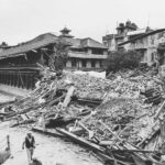 Monochrome image capturing earthquake aftermath in Bhaktapur, Nepal, showing destroyed buildings and debris.