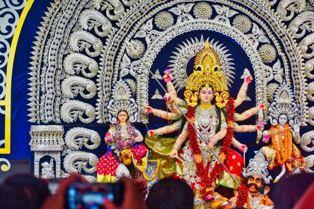Colorful Durga Puja celebration in Bhubaneswar with ornate statues and festive décor.