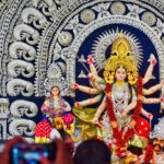 Colorful Durga Puja celebration in Bhubaneswar with ornate statues and festive décor.