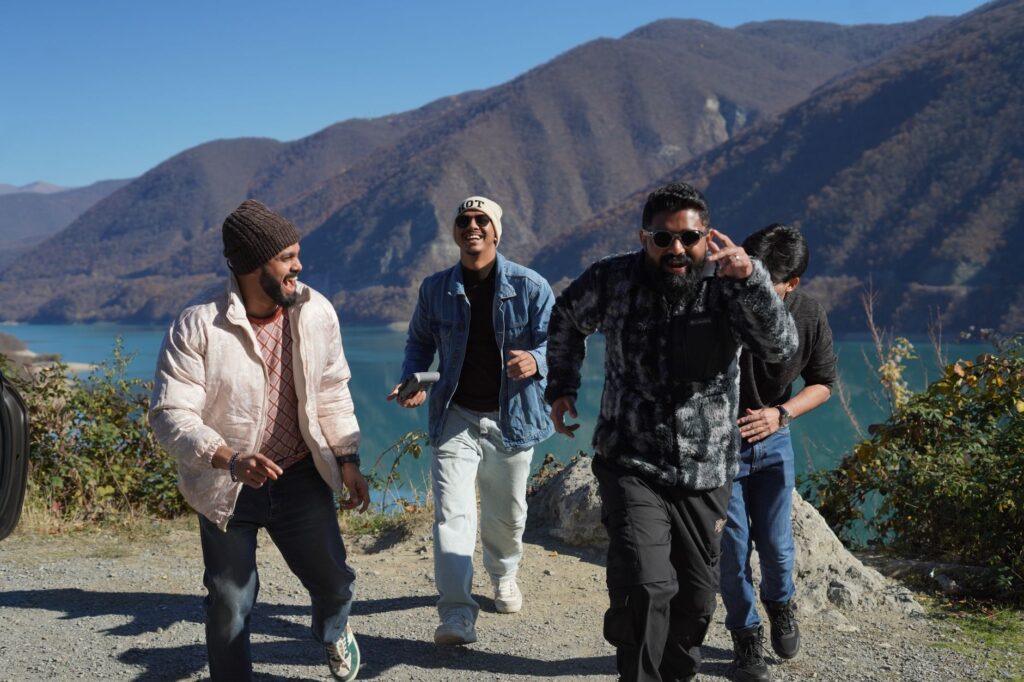 A group of friends having fun while exploring the scenic mountains of Georgia on a sunny day.