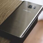 A sleek Samsung smartphone placed on a wooden surface, capturing modern elegance.