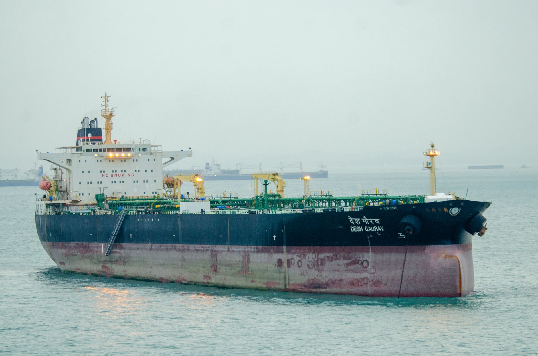 Large cargo ship 'Desh Gaurav' sailing in open sea, showcasing maritime transport.