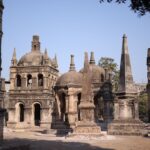 Explore ancient architectural structures in a sunlit historical cemetery, showcasing rich heritage.