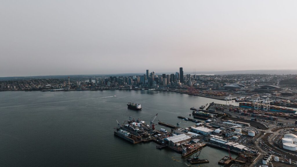 Aerial photography of Seattle's bustling harbor and skyline under a gloomy sky.