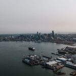Aerial photography of Seattle's bustling harbor and skyline under a gloomy sky.