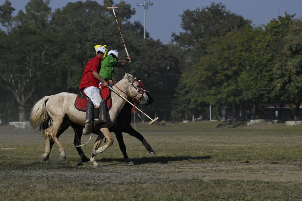Captivating scene of a traditional polo match on a sunny day in Imphal, Manipur, India.