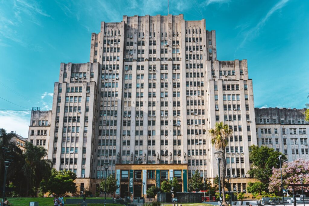 Front view of a grand historical university building with a clear sky backdrop.