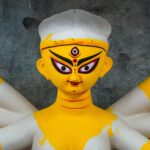 Intricate handcrafted clay idol depicting Goddess Durga in a Kolkata workshop, showcasing traditional Bengali artistry.