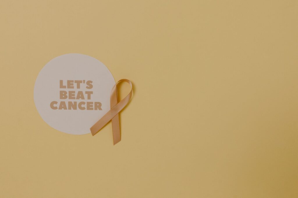 Minimalist design featuring a ribbon and 'Let's Beat Cancer' message for cancer awareness.